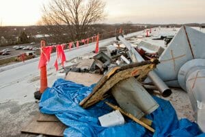 debris from a storm scattered across commercial roof