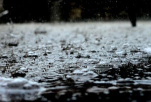 rain falling onto pavement and splashing up