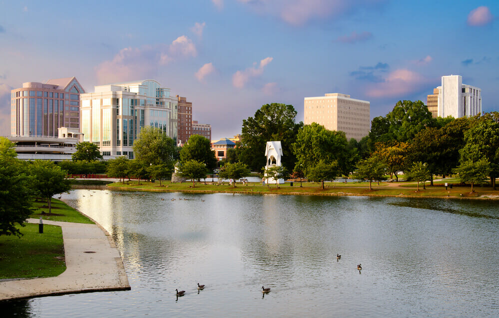 Huntsville, alabama river with skyline of the city in the background with ducks floating on the water