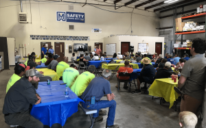 employees celebrating at the Maxwell Roofing office for the employee summer party