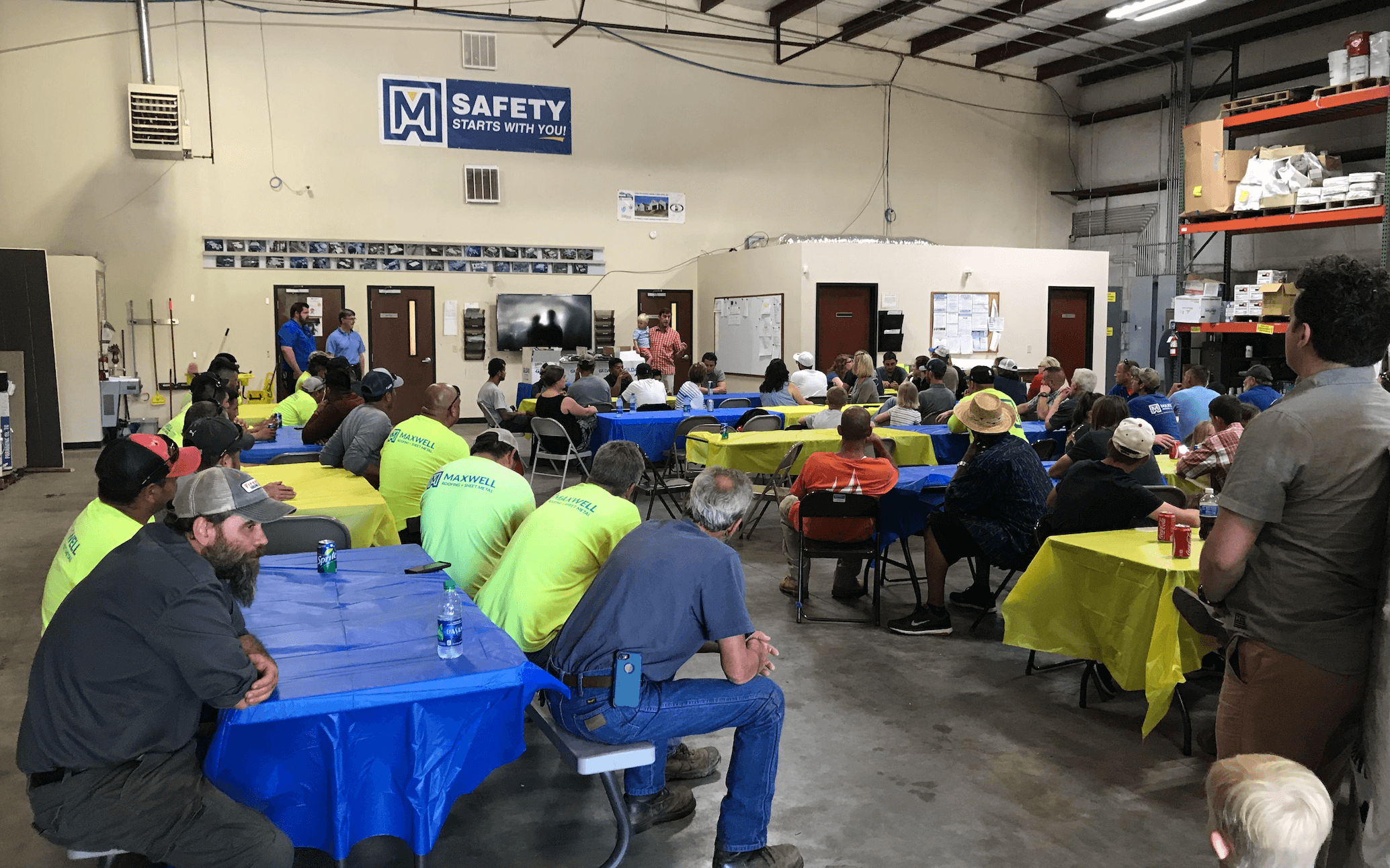 employees celebrating at the Maxwell Roofing office for the employee summer party