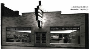 Horrell Company black and white store front with retro sign lit up