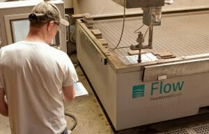 worker preforming in-house fabricating with a Flow waterjet