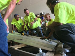 Roofers prefabricating a part