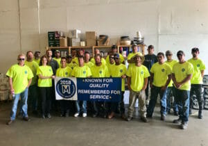 Maxwell roofing team members holding navy banner at the Fall 2018 Professional Skills Workshop