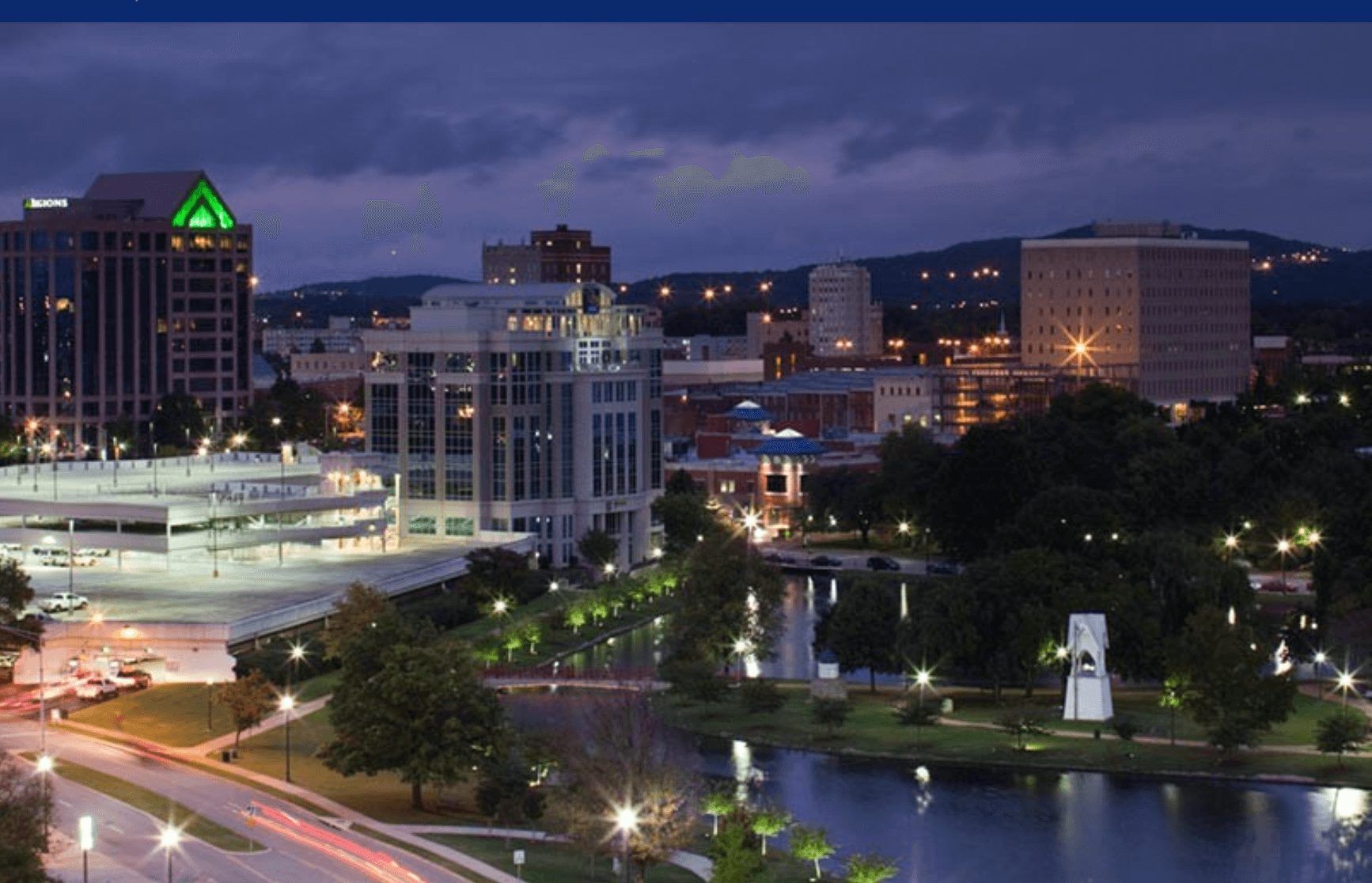 hunstville, alabama at night showcasing the river running through the city and building lights