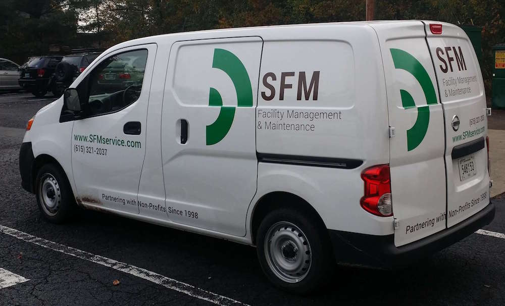 SFM, School Facility Management, service van with green logo on display