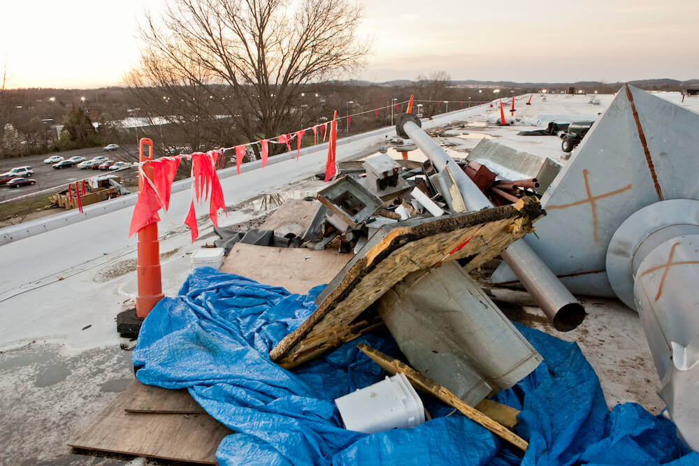 debris from a storm scattered across commercial roof