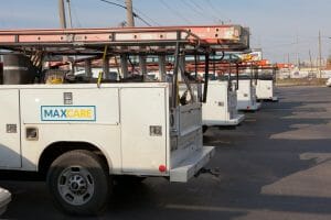 four MAXCare service trucks parked in a row