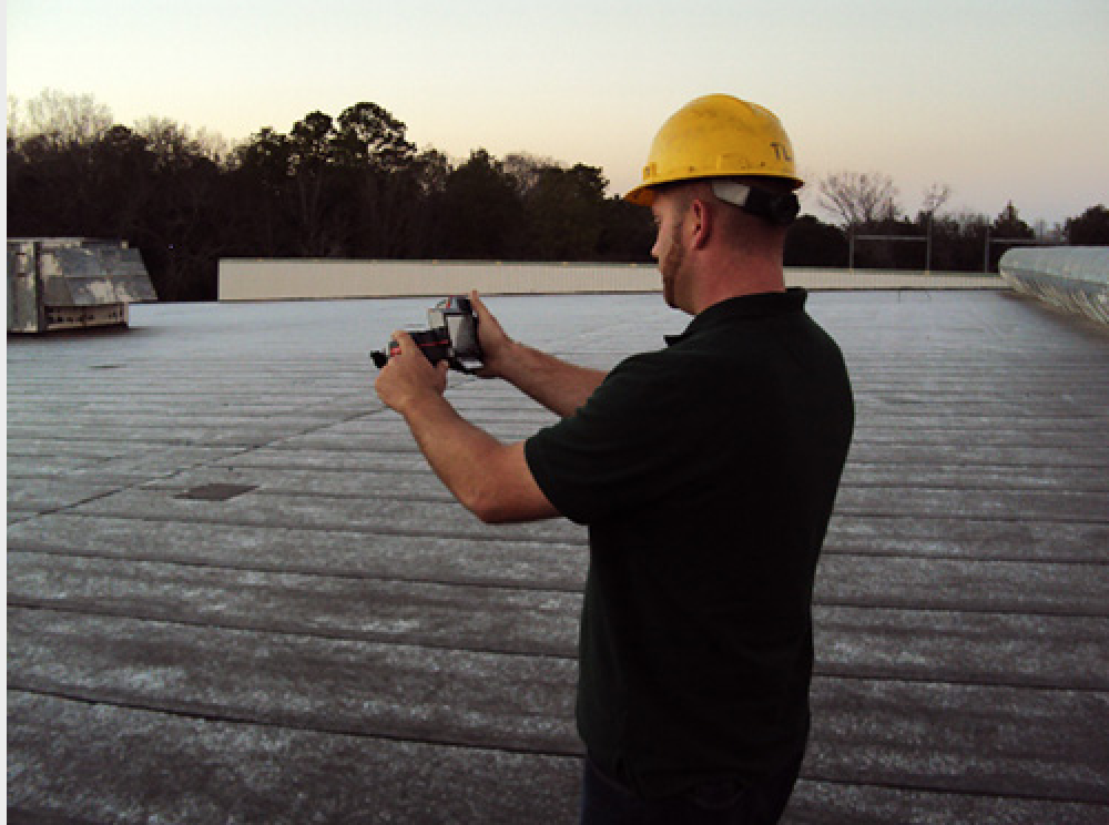 maxwell roofer taking infrared moisture survey on top of roof