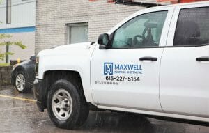 maxwell roofing logo on white service truck