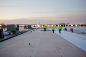 sun setting over maxwell workers on top of a roof