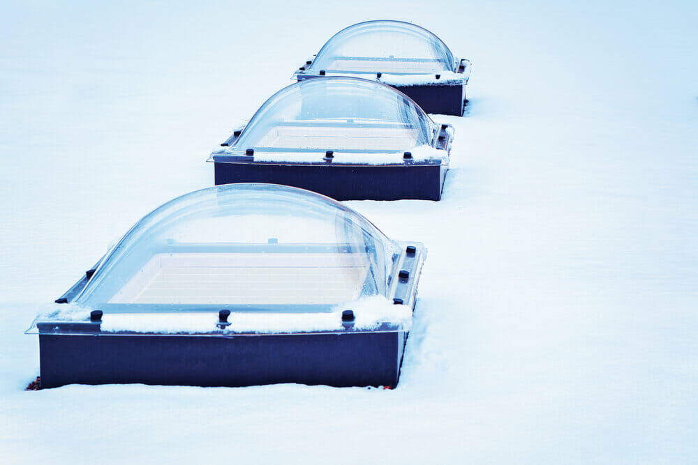 Skylight glass domes on roof of building in snow Helsinki