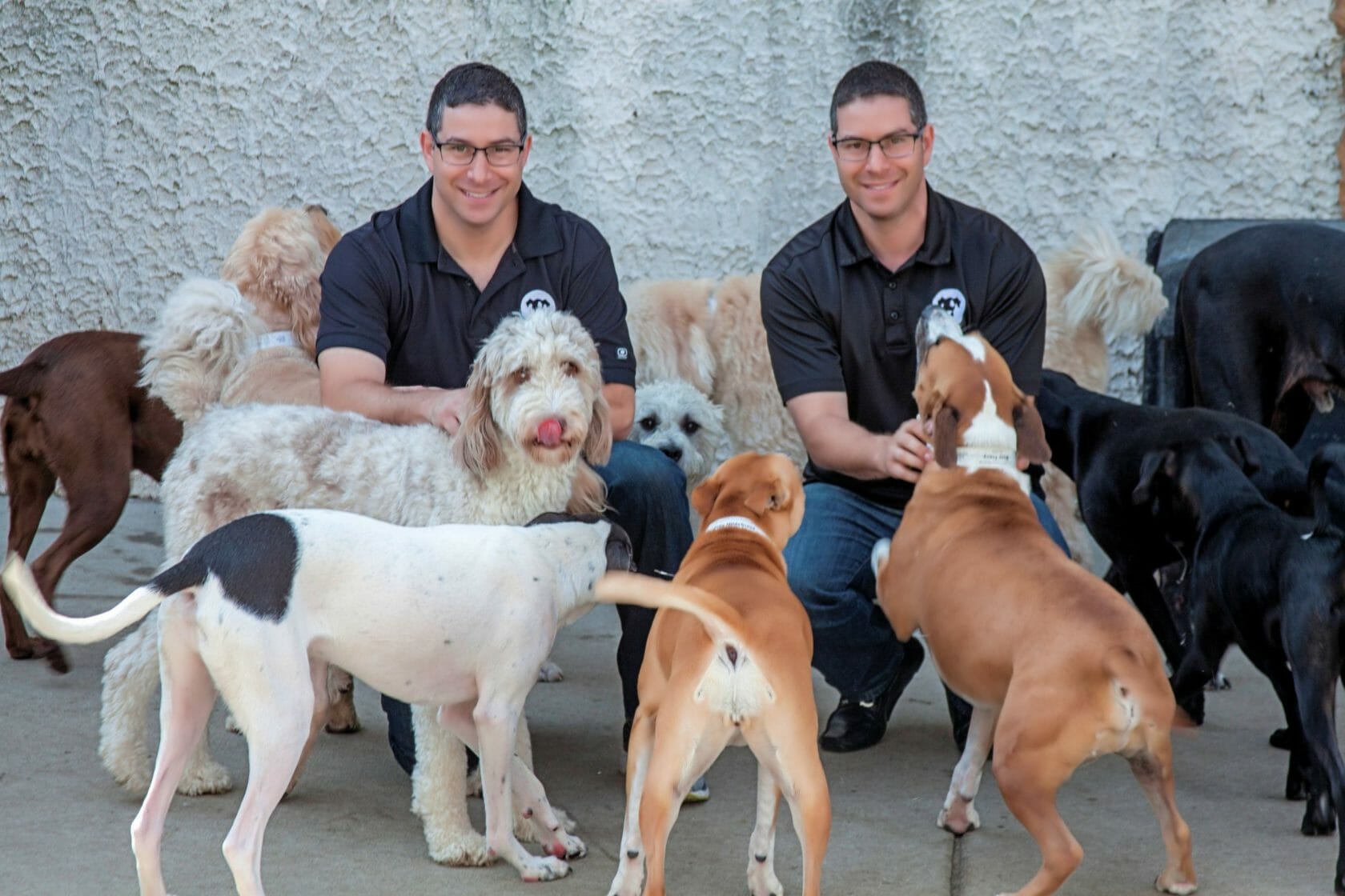 Andy and Chad Baker with dogs, founders of Baker Twin Real Estate and The Dog Spot
