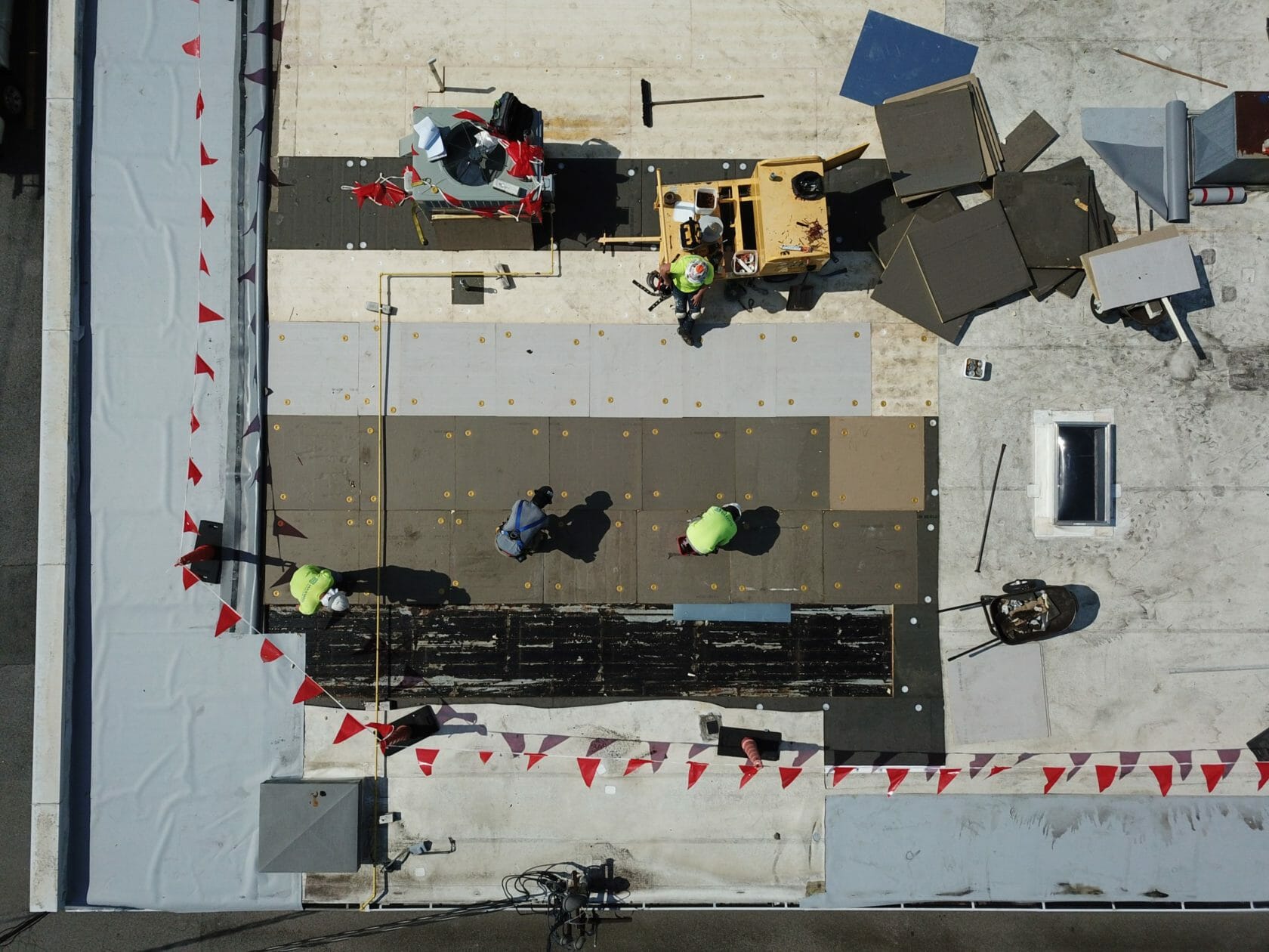 aerial shot of Maxwell roofings working on corner of flat commercial roof