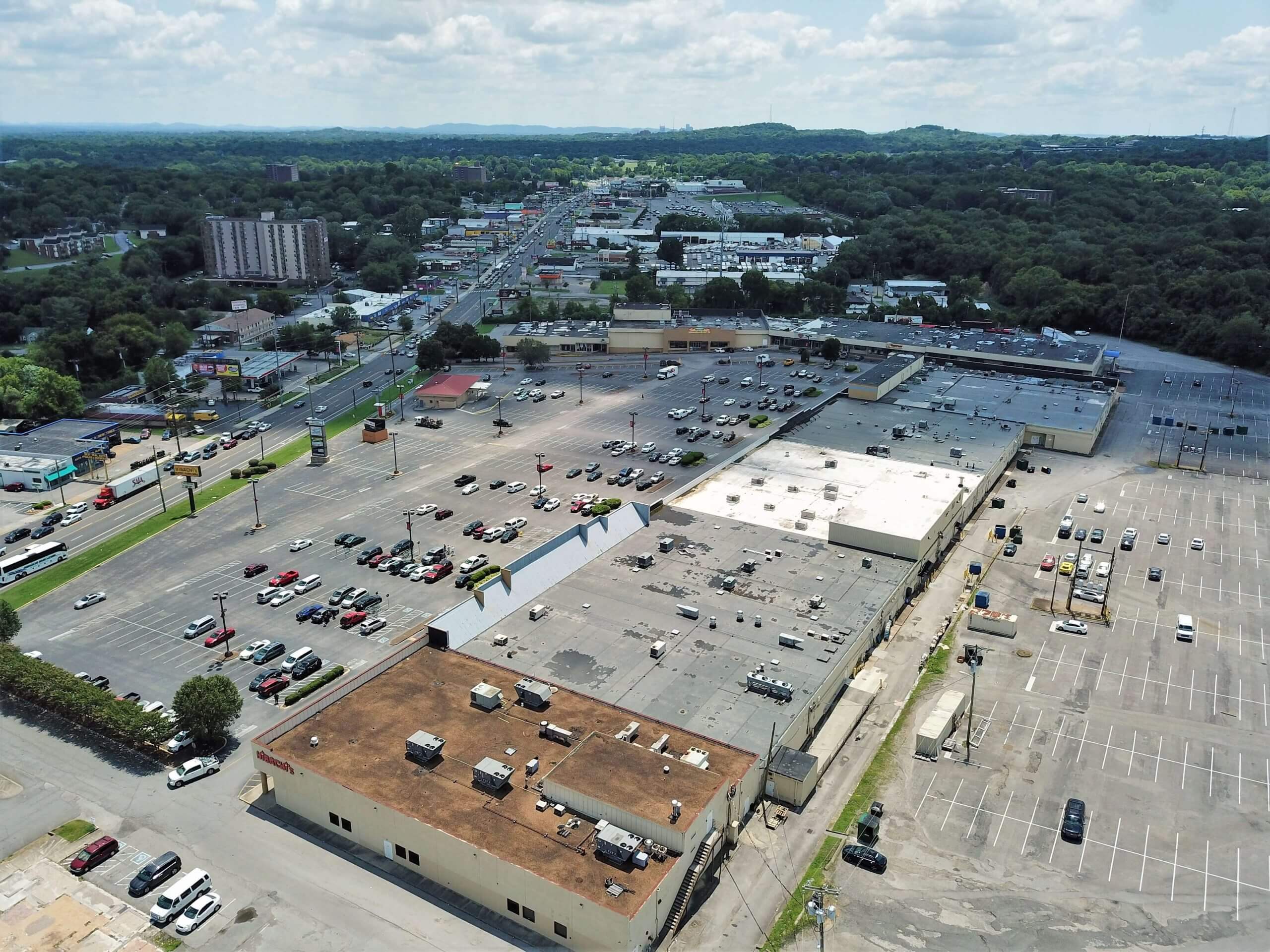 aerial shot of commercial roof with cars in the parking lot