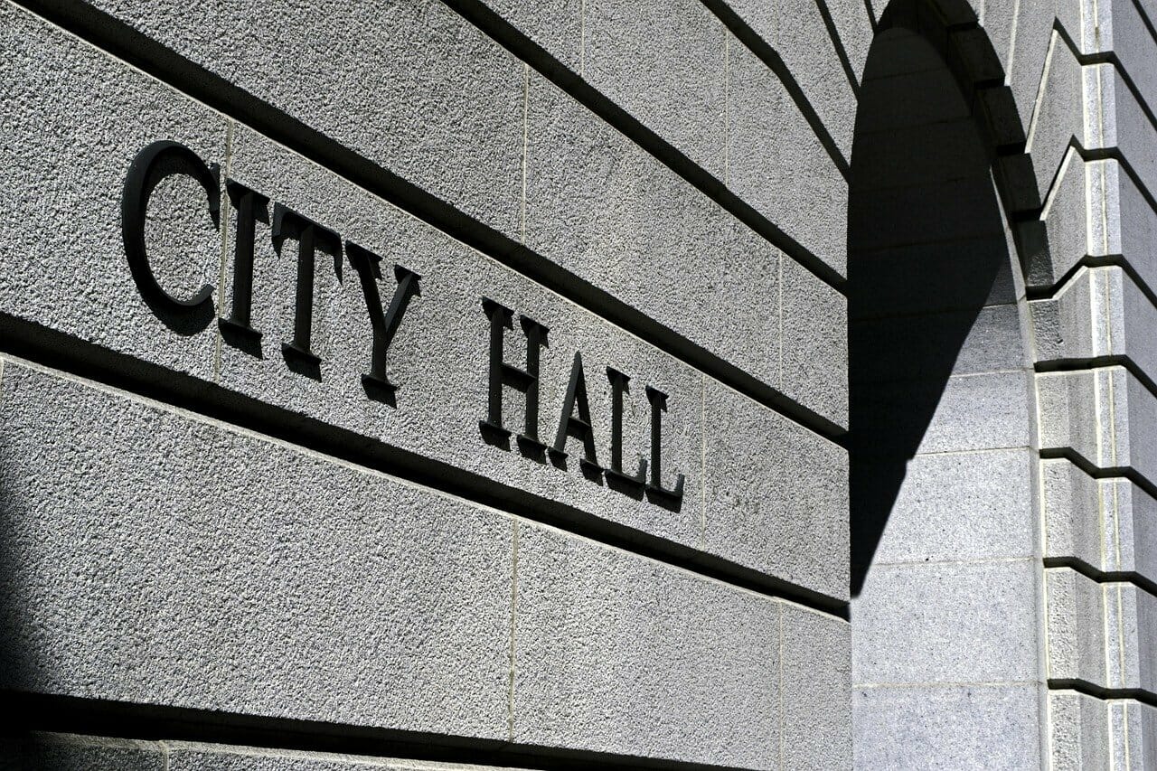 Close up of a city hall sign on a building.