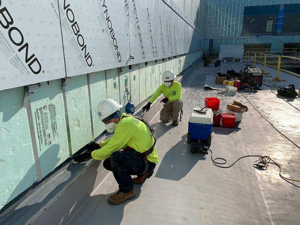 roofing team working on commercial roof.