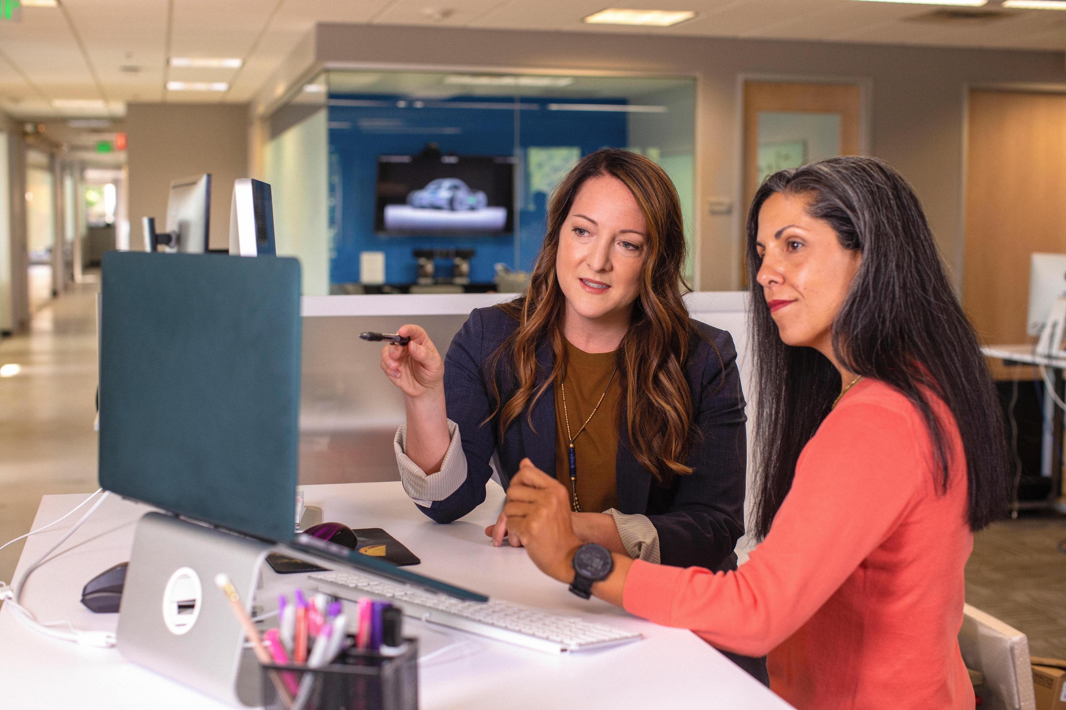 two ladies working in a office