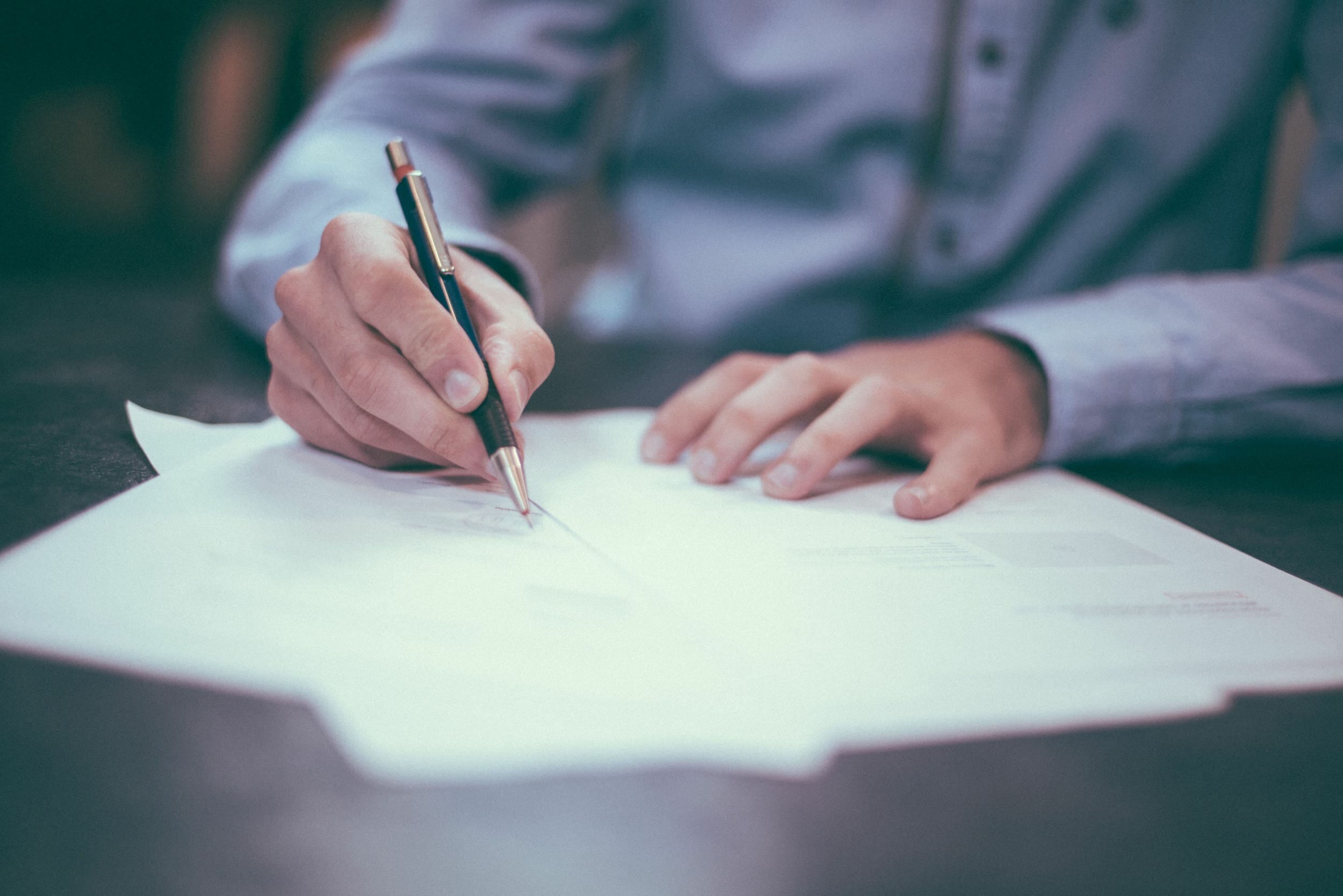 business man writing on document.