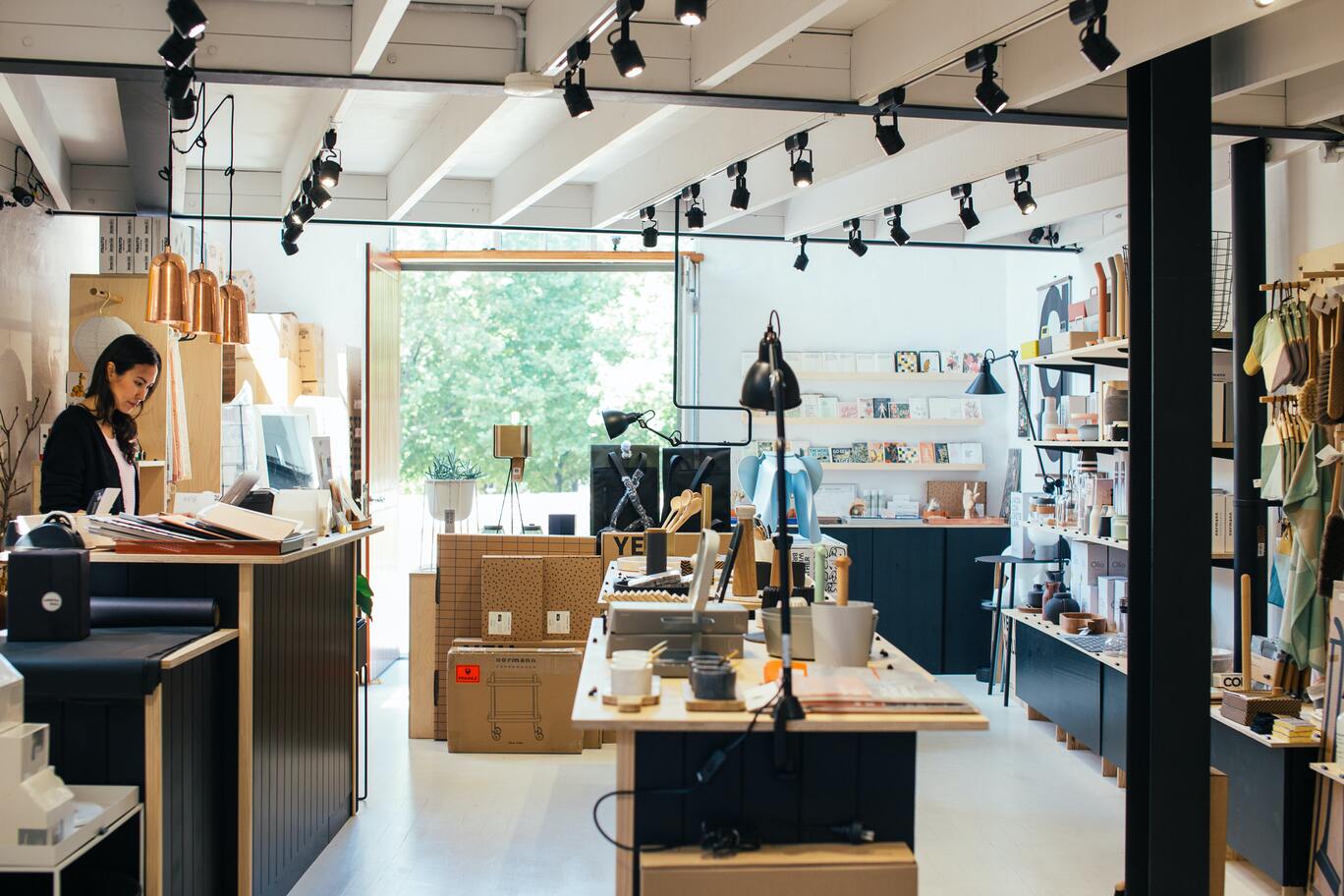 modern gift shop with worker at the counter.