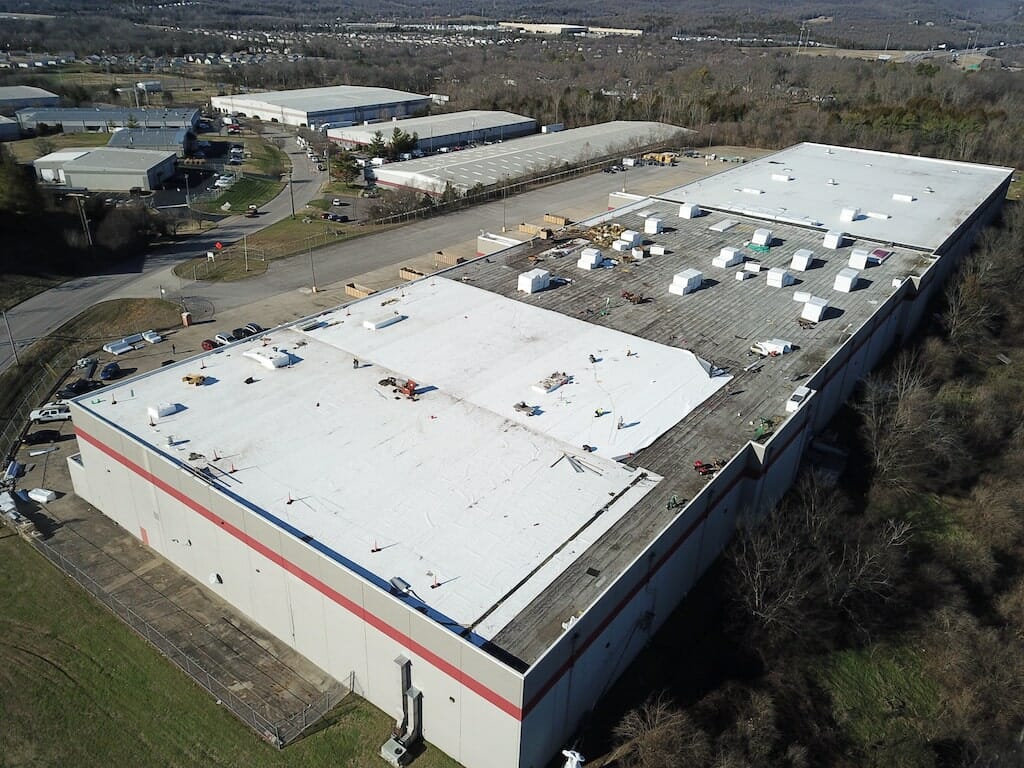 aerial of commerical building with roof being repaired.