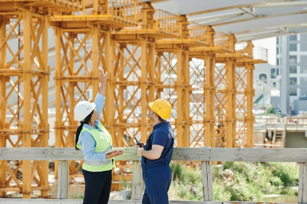 2 construction workers looking at project