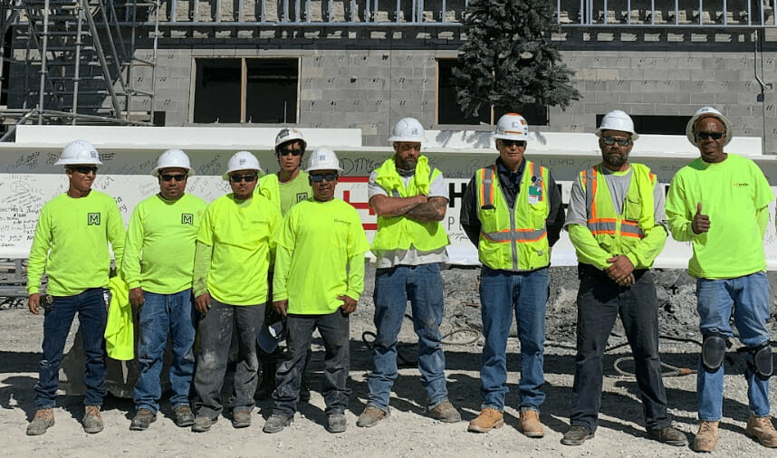 Team of construction workers smiling on a job site